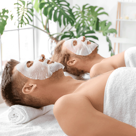 Men doing spa treatment with facial masks